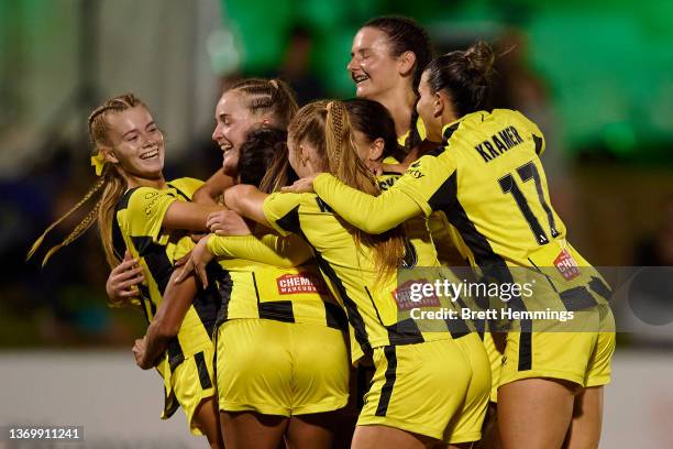 Chloe Knott of Phoenix celebrates scoring a goal with team mates during the round 11 A-League Women's match between Canberra United and Wellington...