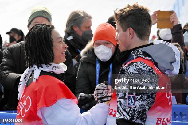 Gold medalist Ayumu Hirano of Team Japan is congratulated by Shaun White of Team United States after the flower ceremony for the Men's Snowboard...