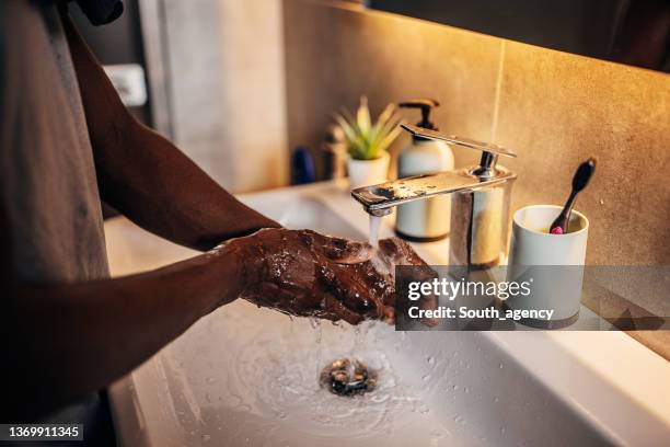 man washing hands in bathroom - washing hands stock pictures, royalty-free photos & images