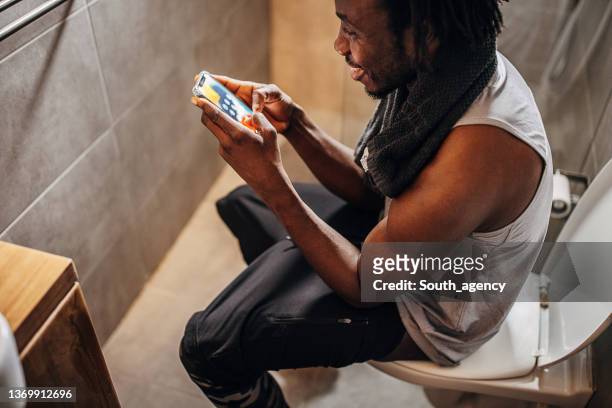 man sitting on the toilet - men taking a dump stock pictures, royalty-free photos & images