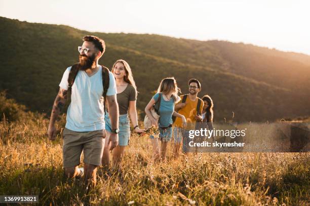 group of happy friends enjoying in their walk on a meadow. - timothy grass imagens e fotografias de stock