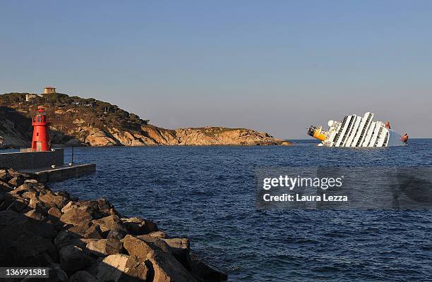 The cruise ship Costa Concordia lies stricken off the shore of the island of Giglio, on January 14, 2012 in Giglio Porto, Italy. More than four...