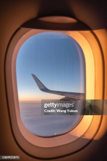 airplane porthole illuminated by the setting sun - porthole stock pictures, royalty-free photos & images