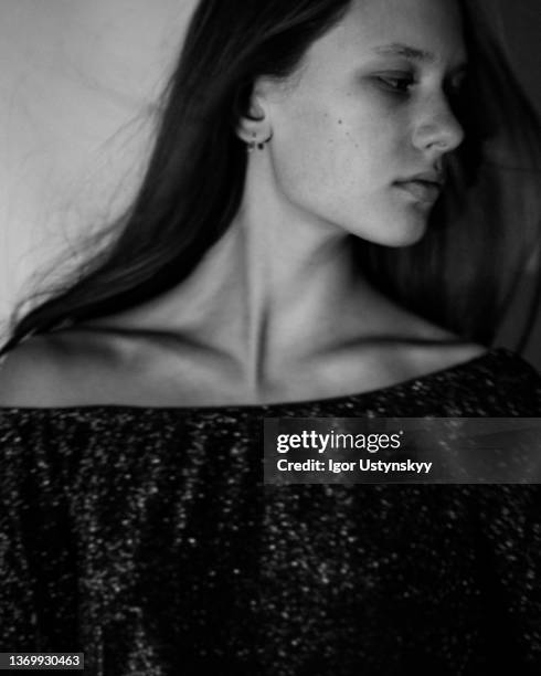 young woman with wind in her hair - clavicle stock pictures, royalty-free photos & images