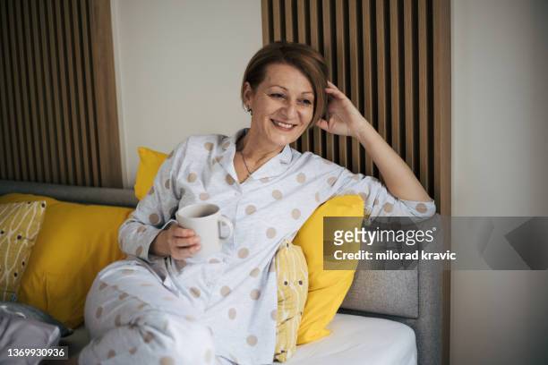 senior woman in bed. - nightwear stock pictures, royalty-free photos & images