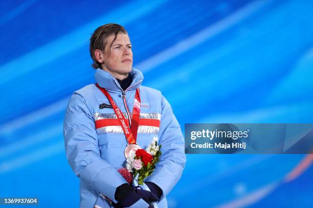 Bronze medallist, Johannes Hoesflot Klaebo of Team Norway stands on the podium during the Men's 15km Classic medal ceremony on Day 7 of the Beijing...