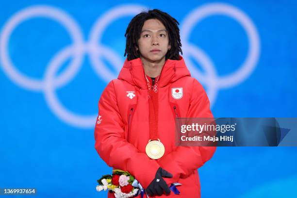 Gold medallist, Ayumu Hirano of Team Japan stands on the podium during the Men's Snowboard Halfpipe medal ceremony on Day 7 of the Beijing 2022...