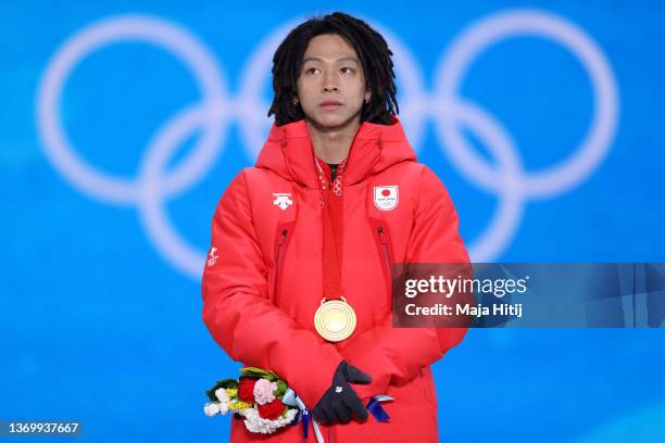 Gold medallist, Ayumu Hirano of Team Japan stands on the podium during the Men's Snowboard Halfpipe medal ceremony on Day 7 of the Beijing 2022...