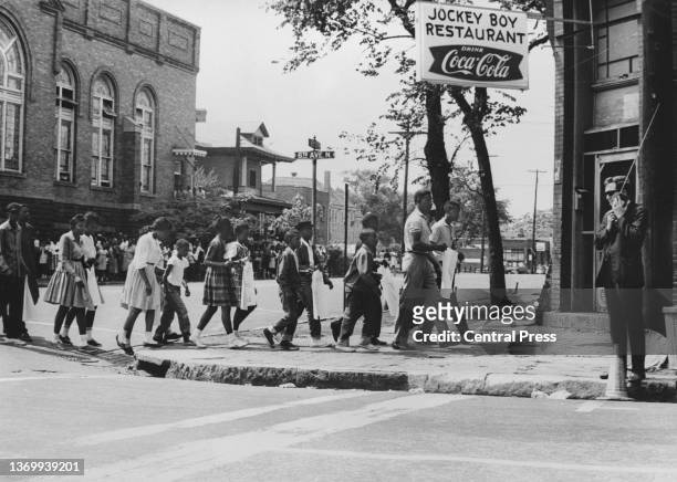 Group of demonstrators of all ages protest against segregation in schools near the 16th Street Baptist Church, headquarters of the American Civil...