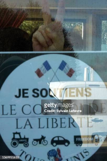 The reflection of the Canadian National Memorial in Vimy northern France is seen in a sticker in a car reading "I support Freedom Convoy" as...