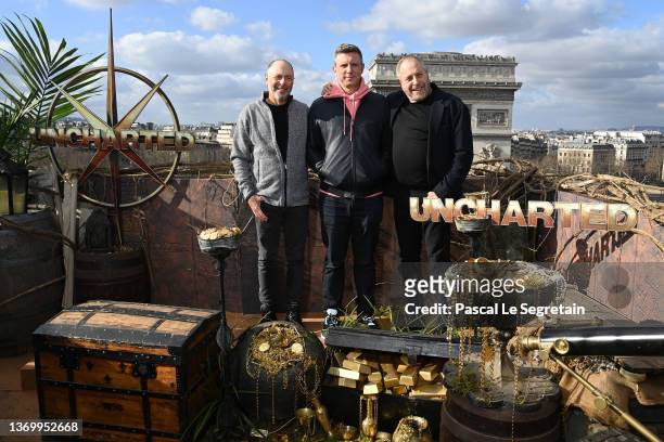 Producer Alex Gartner, director Ruben Fleischer and producer Charles Roven attend the "Uncharted" photocall at cinema Publicis Champs-Elysees on...