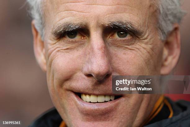 Mick McCarthy the Wolves manager smiles from the dugout during the Barclays Premier League match between Tottenham Hotspur and Wolverhampton...