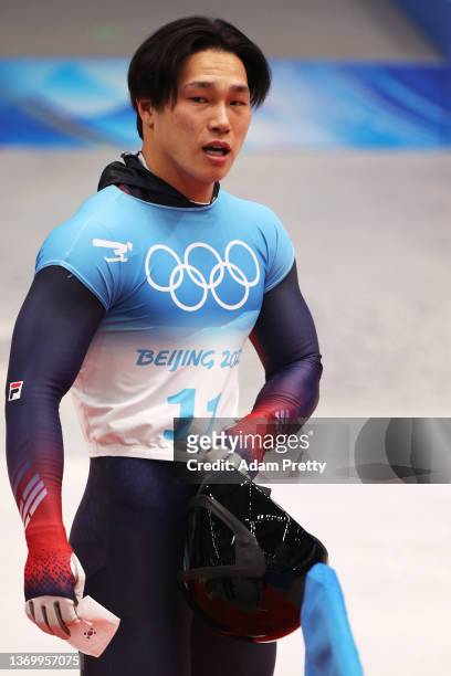 Sungbin Yun of Team South Korea reacts after sliding during the Men's Skeleton Heat 4 on day seven of Beijing 2022 Winter Olympic Games at National...