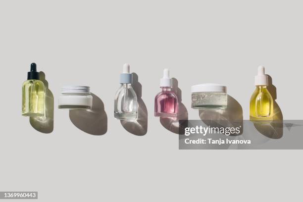 glass bottles for cosmetic products with pipette, natural skincare face cream and essential oil on white background. beauty products concepts - oil liquid ストックフォトと画像