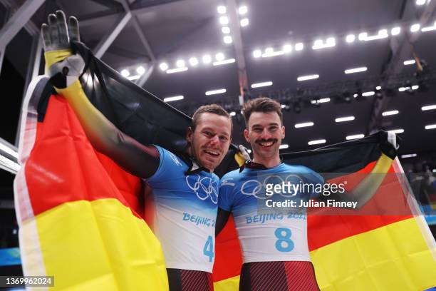 Christopher Grotheer and Axel Jungk of Team Germany react after winning gold and silver respectively during the Men's Skeleton Heat 4 on day seven of...
