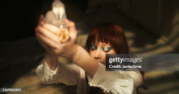 magic ritual in desert tent. woman's hand with a healing crystal. - new age stock pictures, royalty-free photos & images