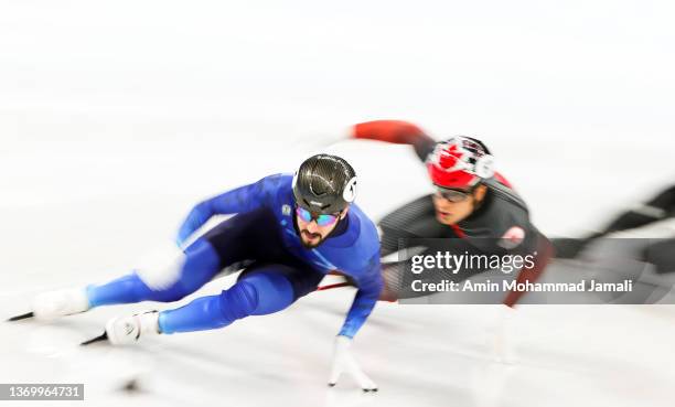 Denis Nikisha of Team Kazakhstan and Jordan Pierre-Gilles of Team Canada compete at the finish line during the Men's 500m Heats on day seven of the...