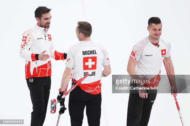 Peter De Cruz, Sven Michel and Valentin Tanner of Team Switzerland celebrate their victory against Team Canada following the Men's Round Robin...