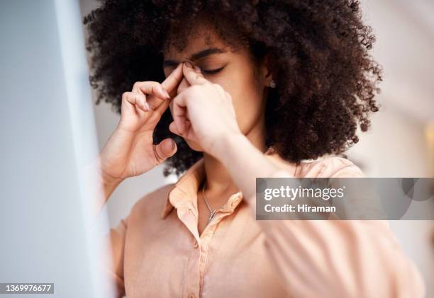 shot of a young woman suffering with a blocked nose and headache at work - sinus stock pictures, royalty-free photos & images