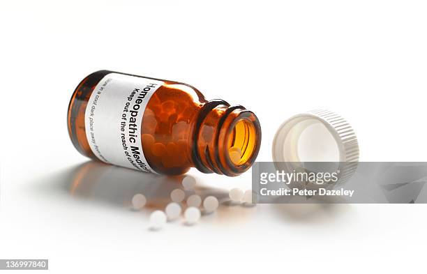 homeopathic pills with copy space - homöopathie stock-fotos und bilder