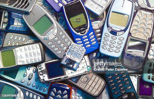 recycling obsolete mobile phones - old phone imagens e fotografias de stock