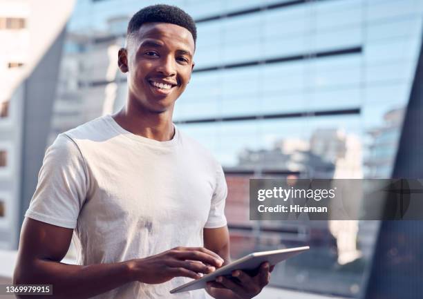 shot of a young businessman using his digital tablet - bring your own device stockfoto's en -beelden