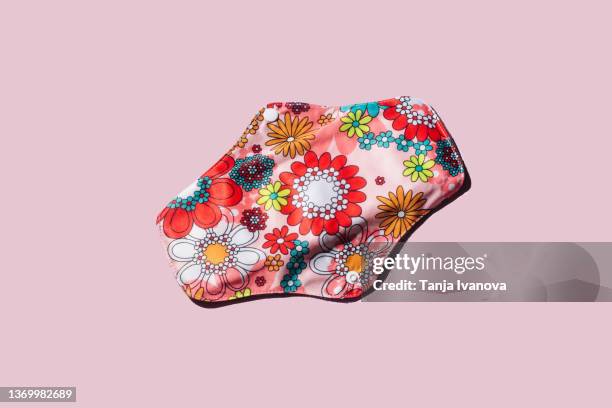 reusable cloth menstrual pad on pink background. - sanitary napkins stock pictures, royalty-free photos & images