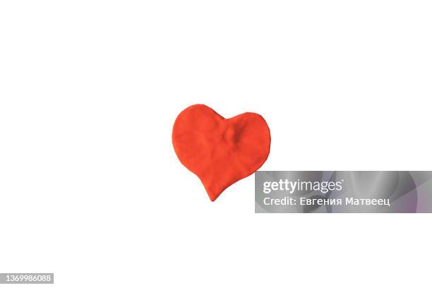 red heart shape molded from plasticine modeling clay isolated on white background close-up - child's play clay stock pictures, royalty-free photos & images