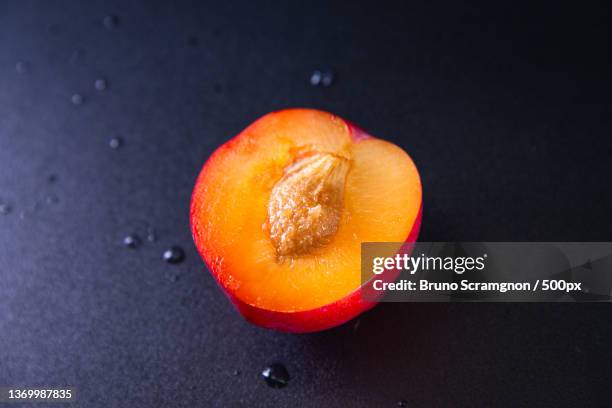 fresh red plum in black background,rio de janeiro,brazil - sobremesa stock pictures, royalty-free photos & images