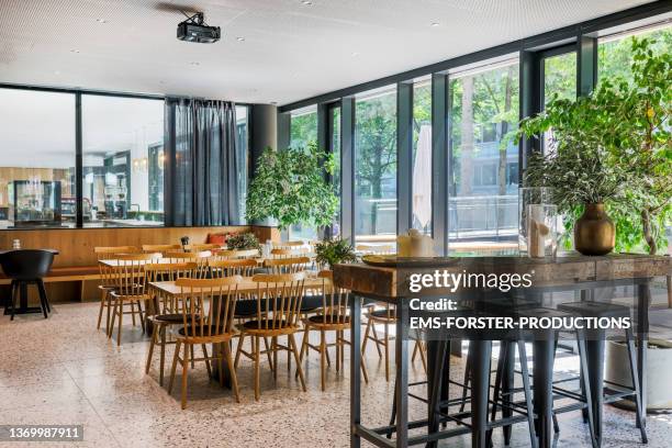 tables and chairs in a empty and trendy restaurant - rent location - sgabello foto e immagini stock