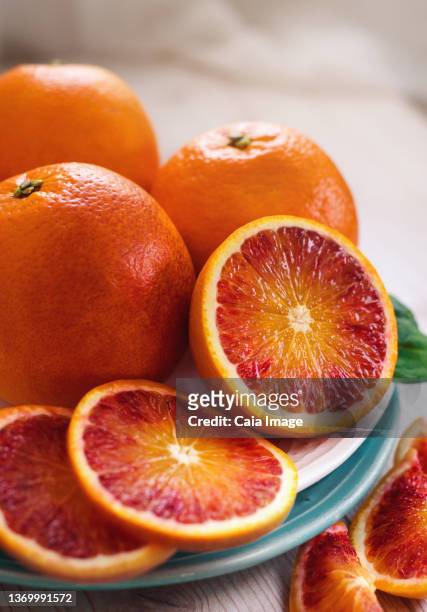 close up sliced fresh blood oranges - blood orange stock pictures, royalty-free photos & images