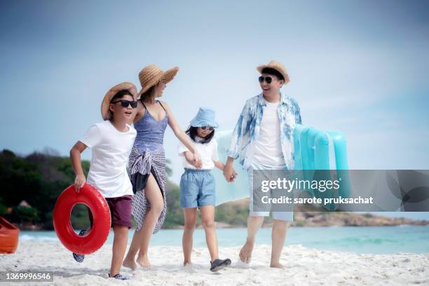 asian family enjoys vacation at the beach holiday . - day 11 stock-fotos und bilder