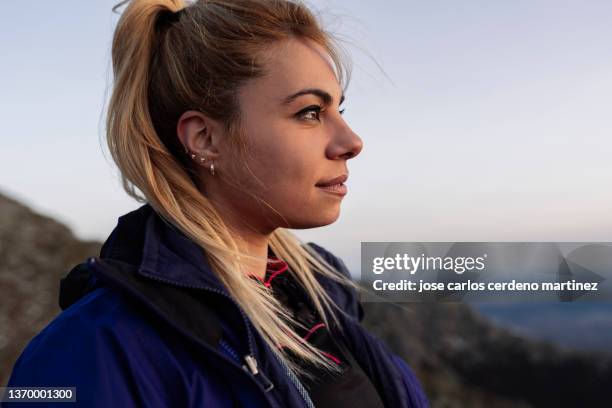 portrait of traveler woman in the mountain at sunset - female profile stock pictures, royalty-free photos & images