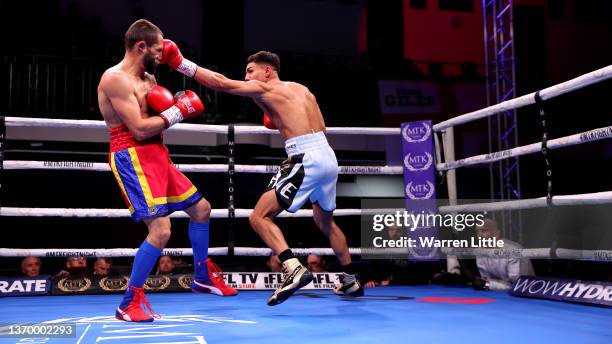 Jordan Flynn punches Marian Marius Istrate during the Lightweight bout between Jordan Flynn and Marian Marius Istrate during the MTK Fight Night at...