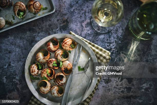 preparing french escargot snails with herb butter - slakkenhuis stockfoto's en -beelden