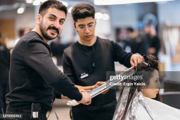 hairdressers  dying hair of young woman at beauty salon - blonde hair dye stock pictures, royalty-free photos & images