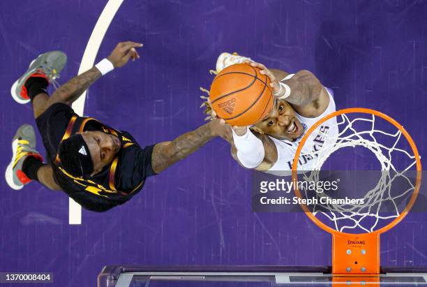 Nate Roberts of the Washington Huskies dunks against Marreon Jackson of the Arizona State Sun Devils during the first half at Alaska Airlines Arena...