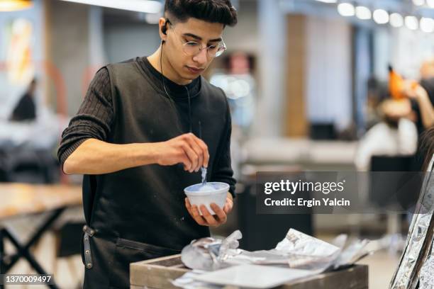 hairdresser mixes hair dye in a bowl - blonde hair dye stock pictures, royalty-free photos & images