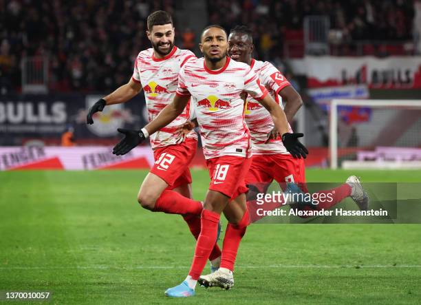 Christopher Nkunku of RB Leipzig celebrates after scoring their sides first goal with team mates Josko Gvardiol and Amadou Haidara during the...