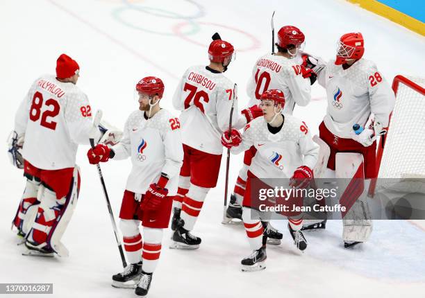 Members of Team Russia skate to their goalkeeper Ivan Fedotov of Russia and celebrate their 2-0 victory over Team Denmark during the Men's Ice Hockey...