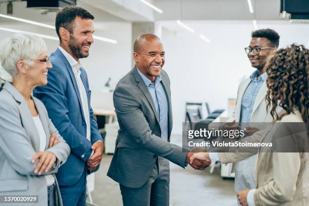successful partnership - corporate business handshake stock pictures, royalty-free photos & images