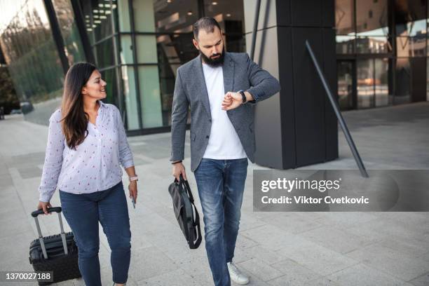 two business colleagues going home after finishing work at the office - returning home after work stock pictures, royalty-free photos & images