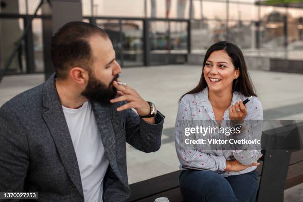 two business people taking a smoking break from the office - vape cigarette stock pictures, royalty-free photos & images
