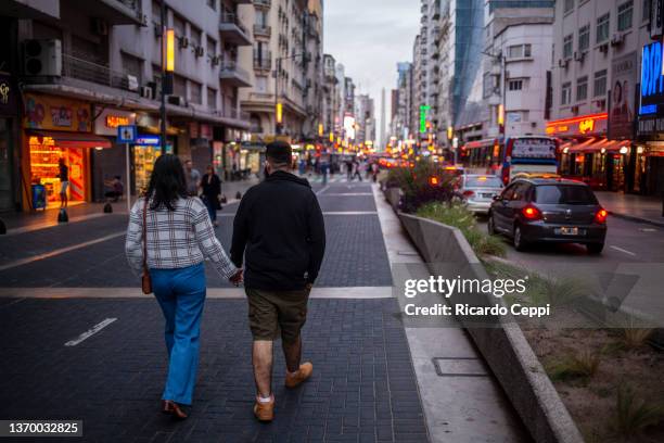 Couple walks in a pedestrian street on February 11, 2022 in Buenos Aires, Argentina. The health pass regulates in Argentina, since January 1 2022,...