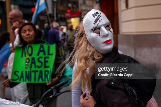 An anti-vaccine woman protester wears a mask during a protest to oppose the health pass on a central avenue in the city on February 11 in Buenos...