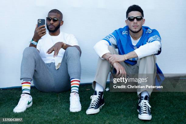 Phoenix Suns players Chris Paul and Devin Booker attend the second round of the WM Phoenix Open at TPC Scottsdale on February 11, 2022 in Scottsdale,...