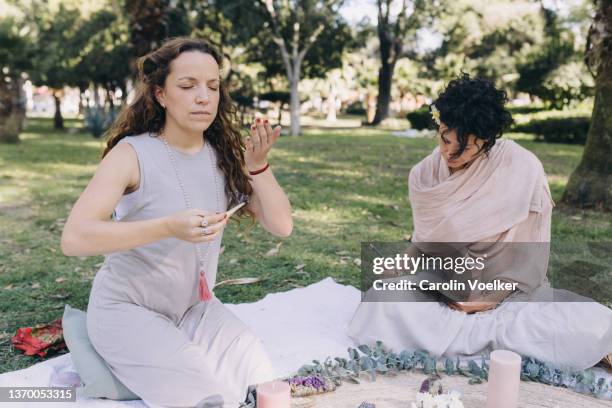 woman holding a burning lignum sappan while writing in a diary - lignum sappan stock pictures, royalty-free photos & images