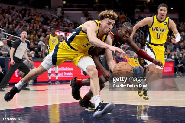 Chris Duarte of the Indiana Pacers and Caris LeVert of the Cleveland Cavaliers battle for a loose ball in the fourth quarter at Gainbridge Fieldhouse...