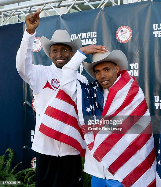 Abdi Abdirahman, left, and Meb Keflezighi point to supporters in the crowd after they qualified during the U.S. Marathon Olympic Trials on January...