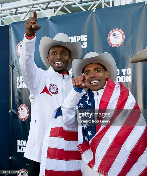 Abdi Abdirahman, left, and Meb Keflezighi point to supporters in the crowd after they qualified during the U.S. Marathon Olympic Trials on January...